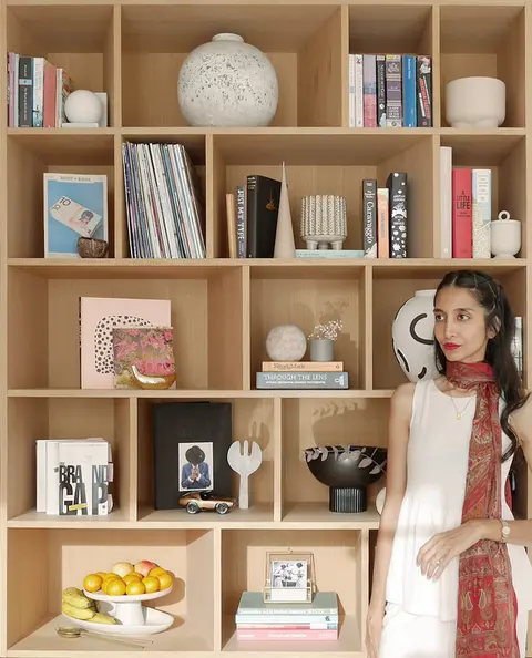 Faten M beside styled oak bookshelves