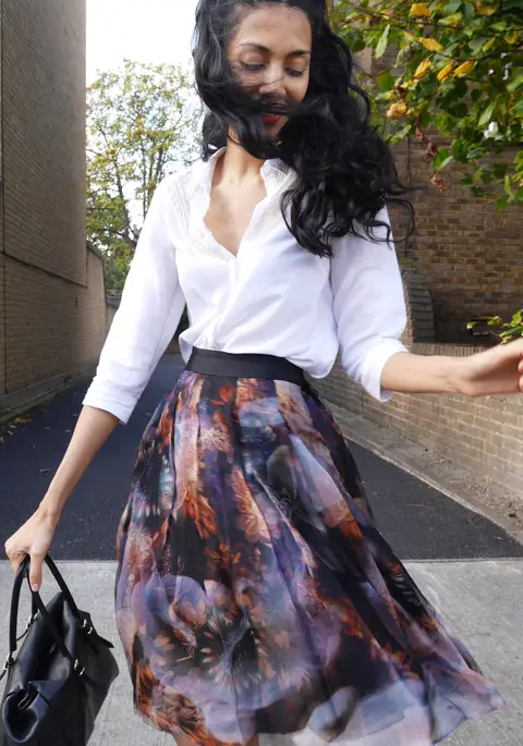 Faten M, interior designer and founder of Londonfatcat Interiors, walking outdoors